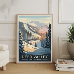 May include: Framed print of a winter landscape featuring a ski resort in Deer Valley, United States. The artwork depicts skiers on a snowy slope, surrounded by pine trees and mountains under a blue sky. The text "DEER VALLEY UNITED STATES" is at the bottom.