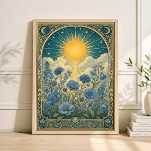 May include: A framed art print featuring a celestial design with a bright yellow sun, blue flowers, and a starry sky. The artwork has a vintage aesthetic with ornate border details and a light wood frame. The color palette includes shades of blue, yellow, and gold.