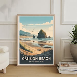 May include: Framed art print depicting Cannon Beach, Oregon, with a coastal scene and a prominent rock formation in the sea. The artwork is in a vintage travel poster style, with a blue sky, sandy beach, and the text "CANNON BEACH, OREGON, UNITED STATES".