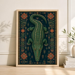 May include: A framed art print featuring a detailed illustration of a green alligator. The artwork has a dark blue background with orange floral and geometric patterns. The alligator is centered, with intricate patterns on its body.