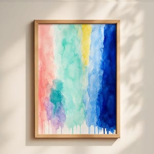 May include: A framed watercolor painting with vertical bands of color. The artwork features a palette of pink, green, yellow, and blue hues. The colors blend and drip downwards, creating a textured effect. The frame is made of light-colored wood.