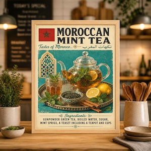 May include: A framed print advertising Moroccan Mint Tea. The image features a glass teapot and cup with mint and lemon, a tray, and text that reads "Moroccan Mint Tea" and "Tastes of Morocco". The ingredients are listed below.