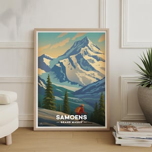 May include: A framed art print with a vintage travel poster design for Samoëns, Grand Massif. The artwork shows a snow-covered mountain range, a skier, and evergreen trees, in blues, greens, and oranges.