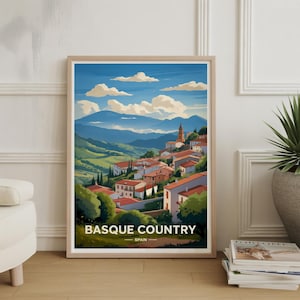 Peut inclure: Impression d'art encadrée du Pays Basque en Espagne. L'œuvre représente un village aux toits de tuiles rouges niché dans des collines verdoyantes sous un ciel bleu avec des nuages blancs. Les mots "BASQUE COUNTRY" et "SPAIN" sont imprimés en bas.