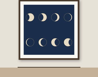 May include: A square wall art piece featuring a dark navy blue background with eight cream-colored moon phases arranged in two horizontal rows of four, all enclosed within a thin dark brown frame against a light beige wall.