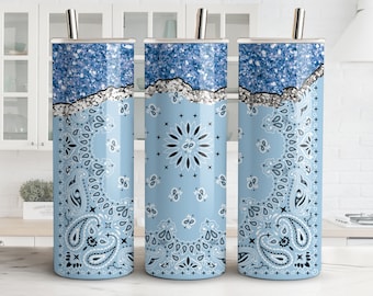 May include: Three stainless steel tumblers with a light blue and white bandana print. The tumblers have a silver glitter accent.