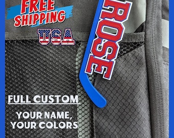 May include: A blue and red hockey stick keychain with the name "ROSE" in red letters. The keychain is attached to a black backpack with a mesh pocket. The text "FULL CUSTOM YOUR NAME, YOUR COLORS" is printed below the keychain.