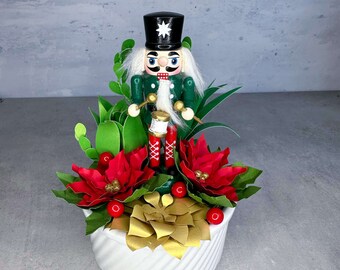 Nutcracker Figure in Paper Flower Succulent and Poinsettia Pot