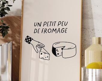 Puede incluir: Una impresión enmarcada con una ilustración en blanco y negro de una mano sosteniendo un trozo de queso y una rueda redonda de queso. El texto en la impresión dice "Un petit peu de fromage".