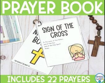 May include: A white prayer book with a metal ring binding, featuring the text "Sign of the Cross" and an illustration of a praying child. The cover reads "Prayer Book" and "Includes 22 Prayers". A wooden cross and rosary beads are visible.