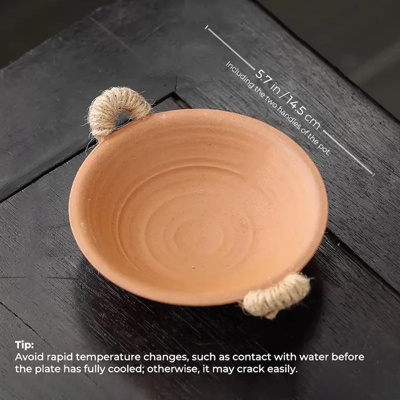May include: A terracotta-colored, shallow bowl with two rope handles. The bowl is 5.7 inches (14.5 cm) in diameter, including the handles. The image includes a tip about avoiding rapid temperature changes to prevent cracking.