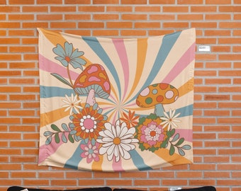 May include: A tapestry with a retro 70s design featuring a swirl of orange, yellow, and pink stripes. The tapestry has a floral pattern with mushrooms and flowers in shades of orange, yellow, pink, red, and green.