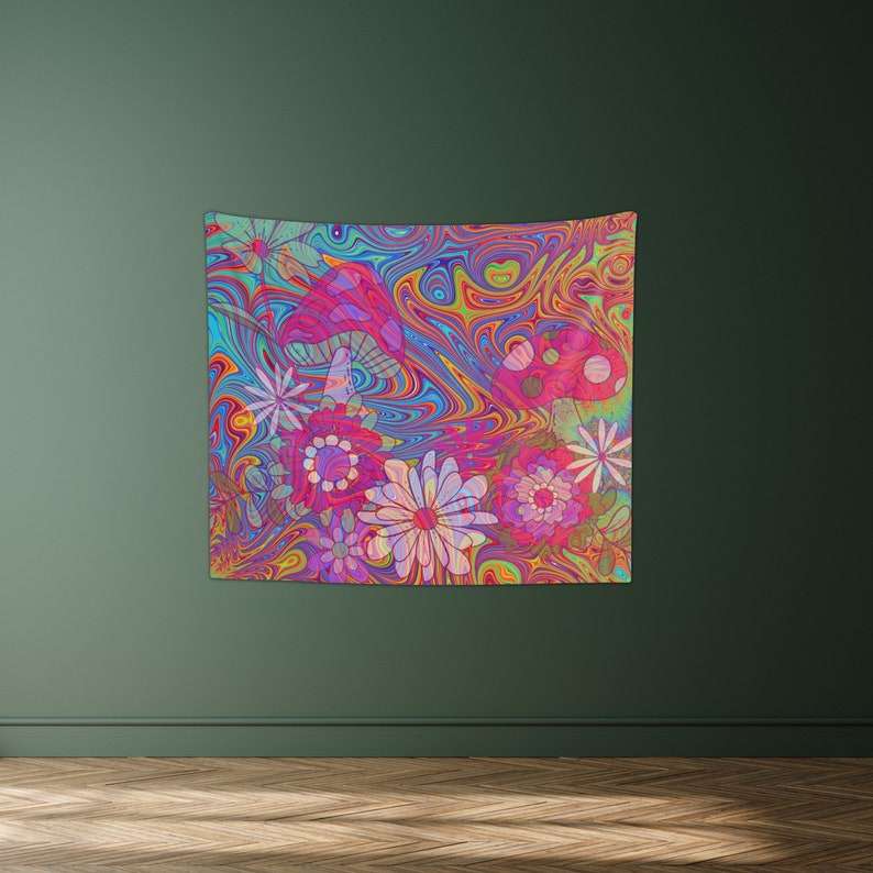 May include: Psychedelic tapestry featuring a swirling, colorful background with pink, blue, and yellow hues. The tapestry has a floral design with pink, white, and yellow flowers and red mushrooms.