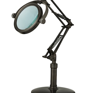 May include: A black metal magnifying lamp with a large round lens and a flexible arm. The lamp has a sturdy base and is adjustable to different angles.