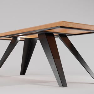 May include: A rectangular wooden table with a black metal frame and four angled legs. The table top is made of light wood with a natural grain.