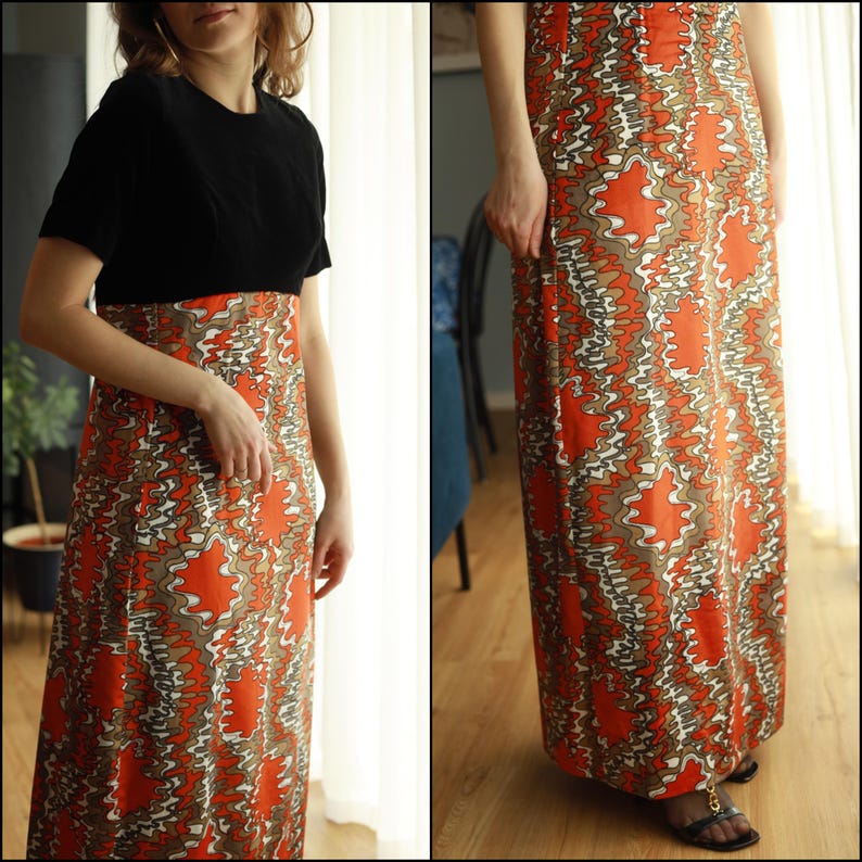 May include: A long, flowing dress with a black top and a colorful, abstract print skirt. The skirt features a swirling pattern of orange, brown, and white.