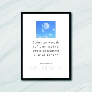 May include: A black framed print with a white background and a blue sky with white clouds. The print features a quote in German: "Optimisten wandeln auf der Wolke, unter der die Pessimisten Trübsal blasen."  The quote is attributed to Charles Joseph de Ligne. The print also includes the word "OPTIMISTEN" in large, bold letters.