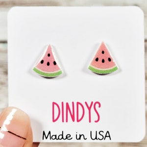 May include: A pair of watermelon slice stud earrings on a white card with the text "Dindys Made in USA".