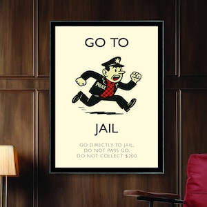 May include: Framed artwork featuring a Monopoly-themed design. The image shows a cartoon police officer running towards the word "JAIL". The text "GO TO" and "JAIL" are prominently displayed, along with the instructions "GO DIRECTLY TO JAIL. DO NOT PASS GO, DO NOT COLLECT $200."