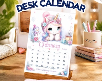 Puede incluir: Un calendario de escritorio 2027 con una página de febrero que muestra una linda ilustración de unicornio, un muñeco de nieve y motivos invernales. El calendario incluye el texto '2027 DESK CALENDAR', 'February', '2027' e 'INSTANT DOWNLOAD'.