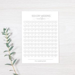 Op de afbeelding: Afdrukbare checklist voor de aftelperiode van 100 dagen tot een bruiloft met een hartvorm voor elke dag. De tekst "100-day wedding countdown" en "Our wedding date" staat bovenaan en onderaan de pagina.