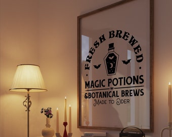 May include: A framed print with the text "FRESH BREWED MAGIC POTIONS & BOTANICAL BREWS MADE TO ORDER" in black. The print features a potion bottle with a bat and moon design. The scene includes a lamp, candles, and decorative items.