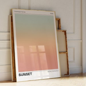May include: A framed print with a gradient background transitioning from light green to orange. The print has the text "Nostalgia Series" and "1990s" in the top corners. The bottom of the print has the text "SUNSET" and "Gallery Exhibition".
