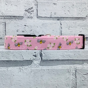 Peut inclure: Collier pour chien rose avec un motif de marguerites blanches et d'abeilles.