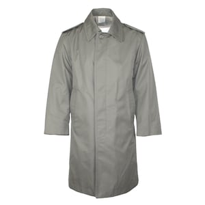 May include: A light gray, single-breasted trench coat with a button closure and a notched collar. The coat has epaulets on the shoulders and a long, knee-length design. The coat is made of a smooth, possibly water-resistant fabric.