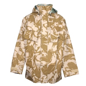 May include: A camouflage jacket with a hood. The jacket is in a desert camouflage pattern with brown, tan, and white colours.