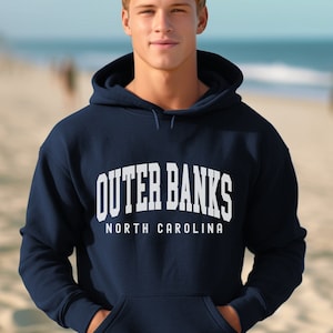 May include: A navy blue hooded sweatshirt with the text "Outer Banks North Carolina" in white.
