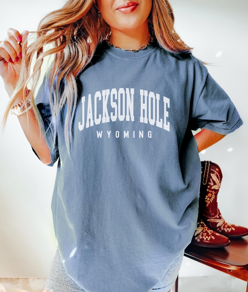 May include: A blue oversized t-shirt with white text that reads "JACKSON HOLE WYOMING".