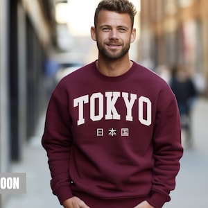May include: Maroon sweatshirt with a white graphic print that says "TOKYO" and "日本国" in Japanese.