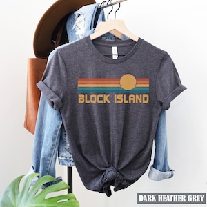 May include: Dark heather grey t-shirt with a retro sunset graphic and the text "Block Island".