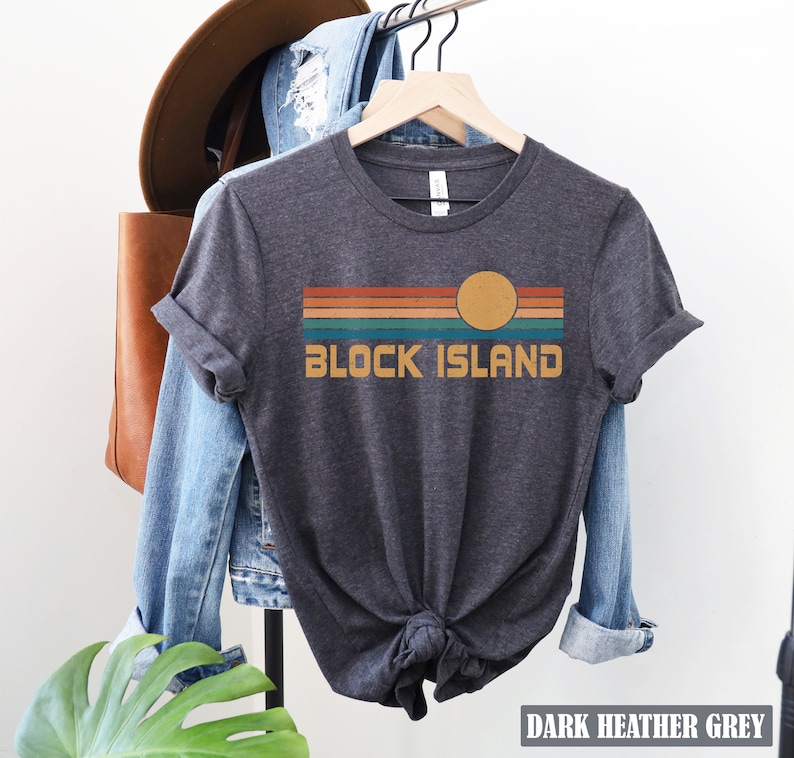 May include: Dark heather grey t-shirt with a retro sunset graphic and the text "Block Island".