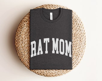 May include: A dark gray t-shirt with the text "RAT MOM" in white letters.