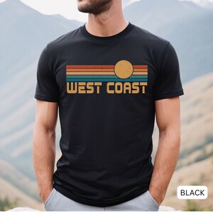 May include: A black t-shirt with a retro sunset graphic and the text "WEST COAST" in yellow.