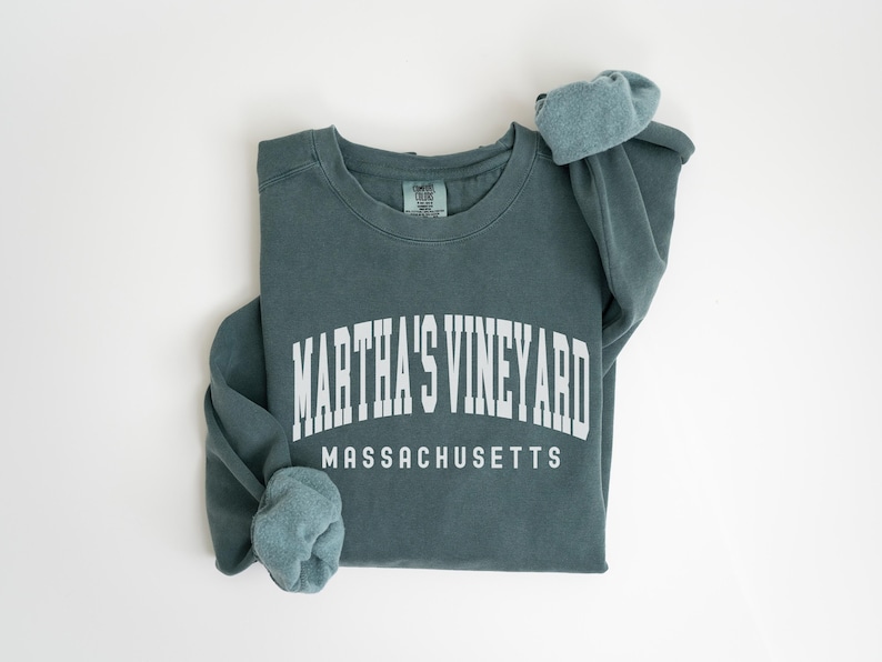 May include: A teal blue sweatshirt with the text "Martha's Vineyard Massachusetts" in white.