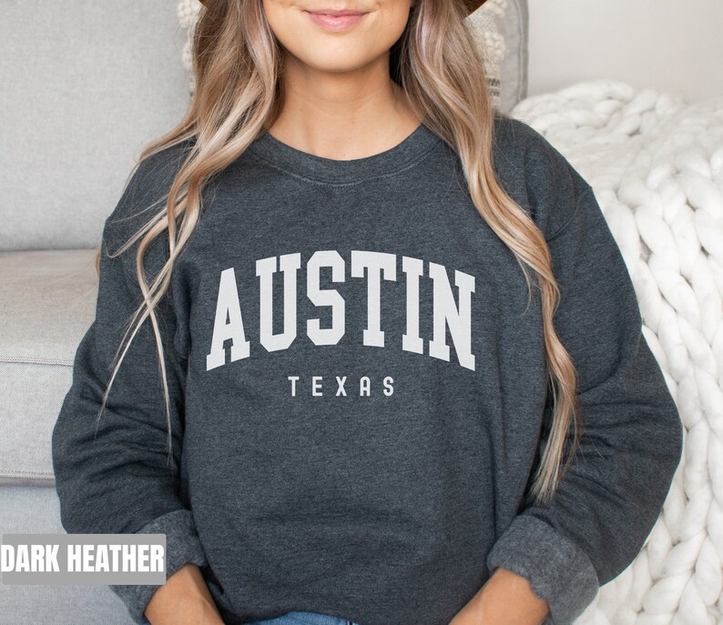 May include: Dark heather grey sweatshirt with the text "AUSTIN TEXAS" in white.