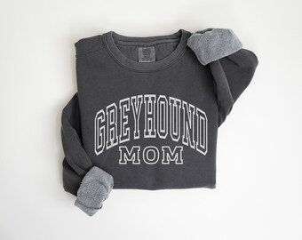 May include: A charcoal grey sweatshirt with the text "Greyhound Mom" in white outlined letters.