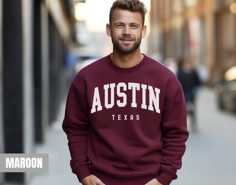 May include: Maroon sweatshirt with white text that reads "AUSTIN TEXAS".