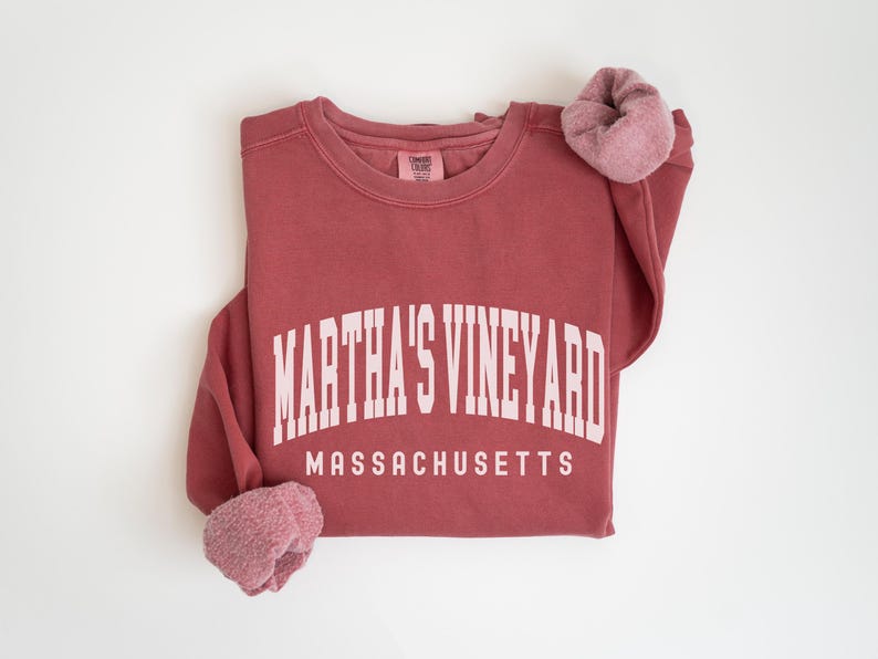 May include: A maroon sweatshirt with the text "Martha's Vineyard Massachusetts" in white.