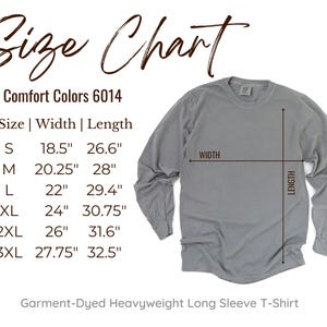 May include: A gray long-sleeve t-shirt with a size chart. The chart shows measurements for sizes S to 3XL, with widths ranging from 18.5 inches to 27.75 inches and lengths from 26.6 inches to 32.5 inches. The shirt is garment-dyed heavyweight.