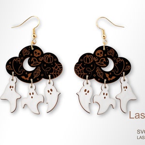 May include: A pair of black and white wooden earrings with a cloud shape and dangling ghosts. The cloud is decorated with a crescent moon, stars, pumpkins, bats, and other Halloween-themed imagery. The text "LaserArtist studio" and "SVG / PDF / DXF LASER READY FILES" is visible at the bottom of the image.