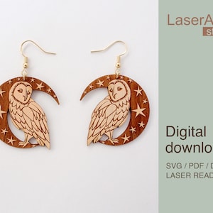 May include: A pair of laser cut wooden earrings featuring a crescent moon with stars and an owl. The earrings are brown with a light brown owl and stars. The text "LaserArtist studio" and "Digital download SVG / PDF / DXF LASER READY FILES" is in the background.