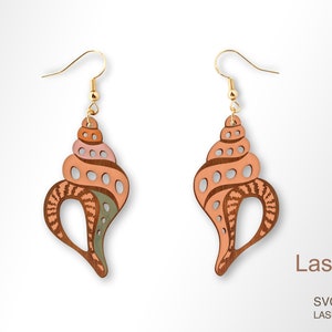 May include: A pair of wooden earrings shaped like seashells with intricate cutouts and a pink, brown, and green color scheme. The earrings are laser cut and ready to be assembled.