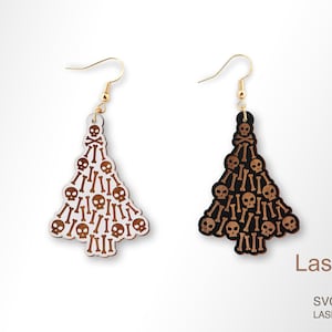 May include: A pair of wooden earrings shaped like Christmas trees, decorated with a skull and crossbones pattern. The earrings are available in black and white.