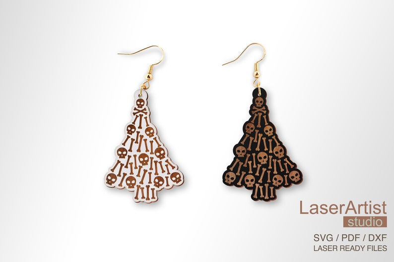May include: A pair of wooden earrings shaped like Christmas trees, decorated with a skull and crossbones pattern. The earrings are available in black and white.