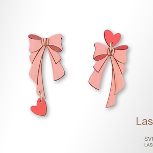 May include: A pair of pink wooden earrings with a bow and heart charm. LaserArtist studio SVG / PDF / DXF laser ready files.