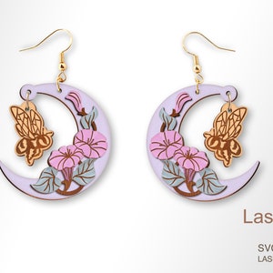 May include: A pair of crescent moon earrings with a delicate floral design and a small bee charm. The earrings are made of wood and painted in shades of purple, pink, and green.